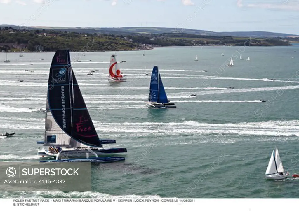 Maxi-trimarans leaving Cowes in the RORC Rolex Fastnet Race. Isle of Wight, England, August 2011. All non-editorial uses must be cleared individually.