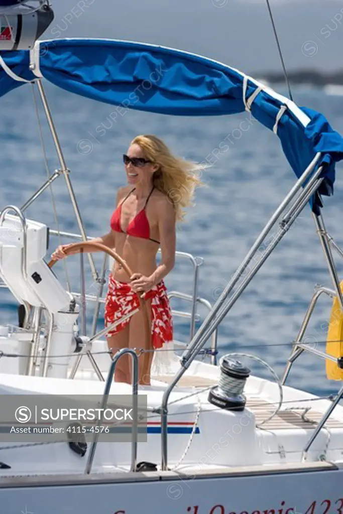 Woman sailing a Sunsail Oceanis 423 yacht in the BVI's, March 2006. Model and property released.