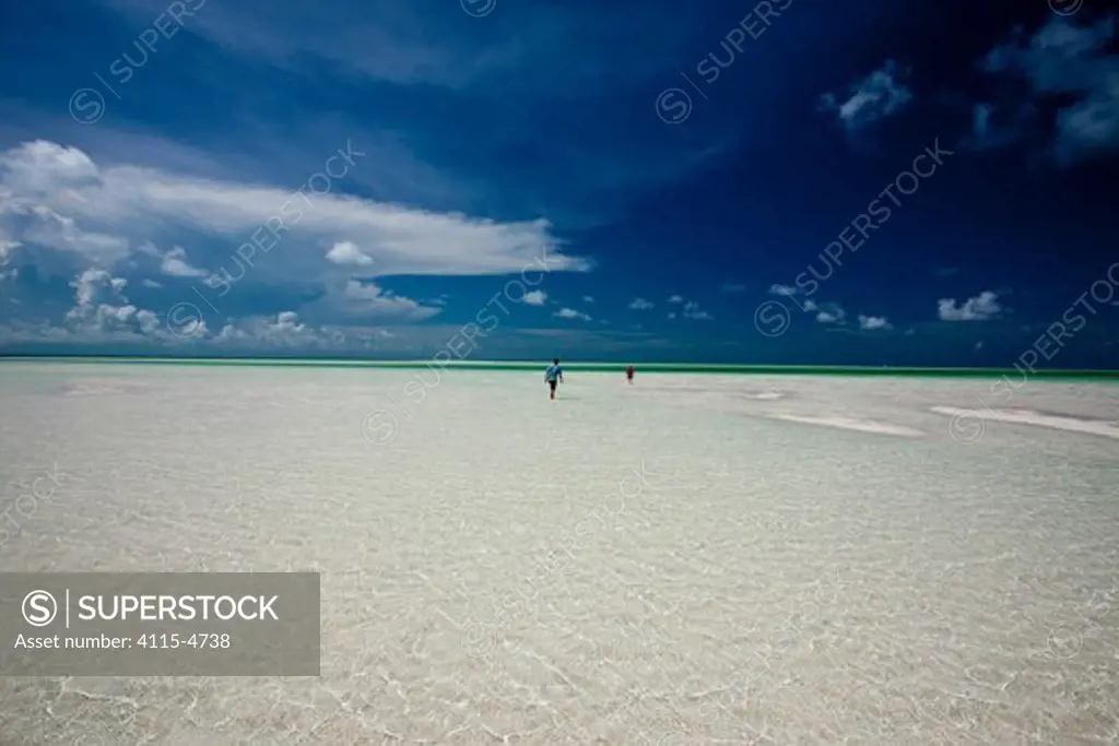 Distant people in the shallows of the Exumas, Bahamas, Caribbean. June 2009. Model released.