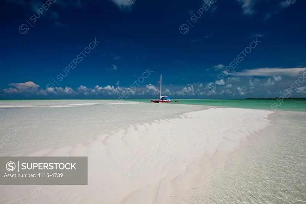 30ft Tiki catamaran 'Abaco' pulled up near sand bank in the Exumas, Bahamas, Caribbean. June 2009. Property released.