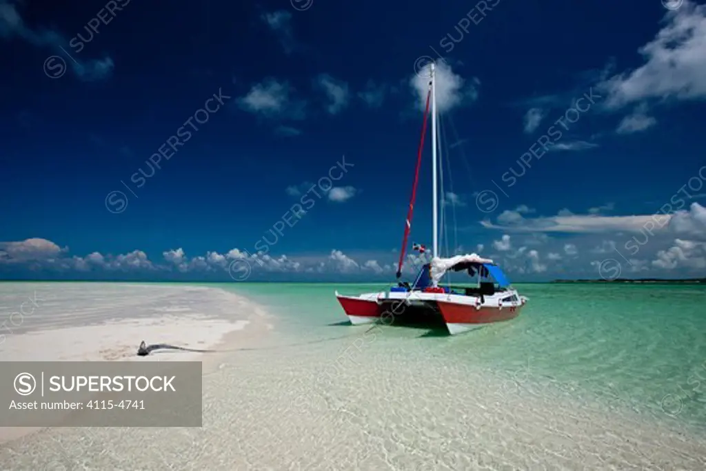 30ft Tiki catamaran 'Abaco' anchored by sand bank in the Exumas, Bahamas, Caribbean. June 2009. Property released.