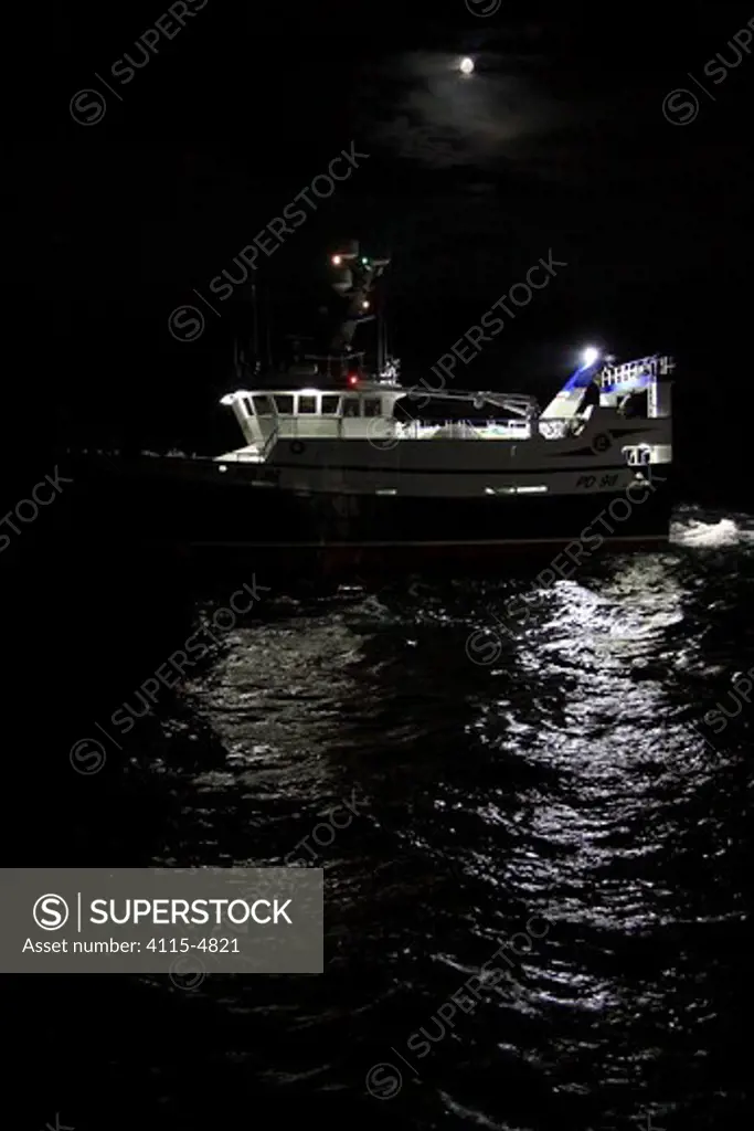 Fishing vessel 'Harvester' trawling on the North Sea at night, September 2010. Property released.