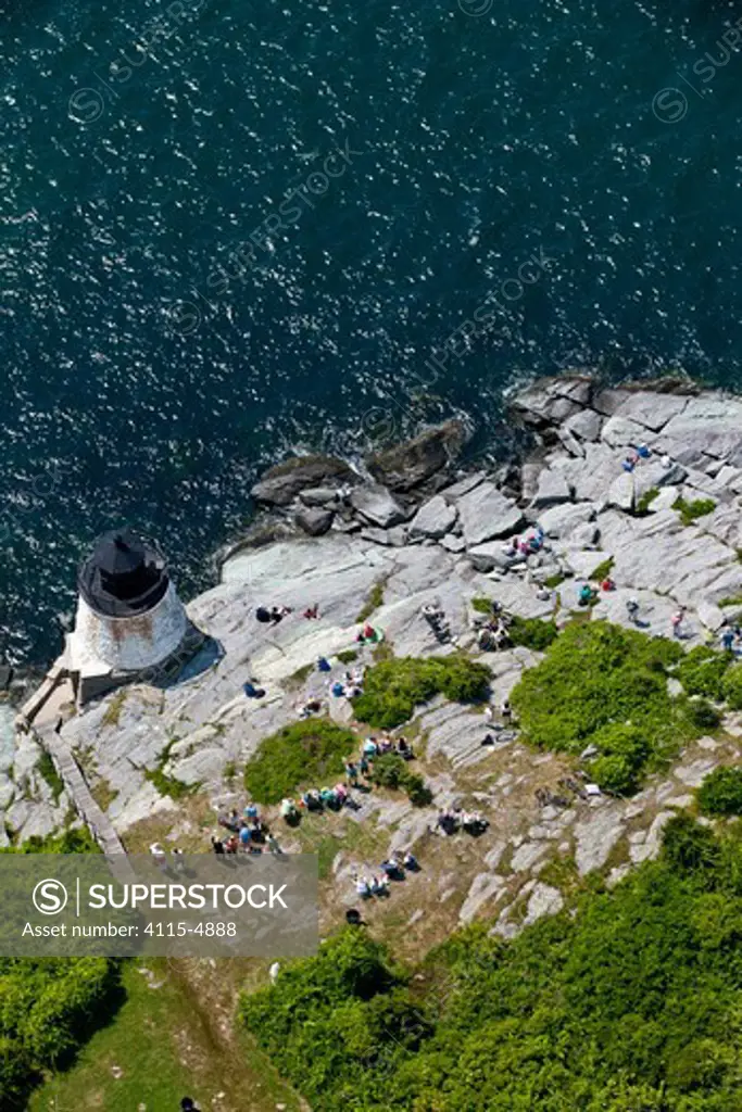 Aerial view of spectators gathering on the rocks by Castle Hill lighthouse at the beginning of the Newport-Bermuda Race, Rhode Island, USA, June 2010.