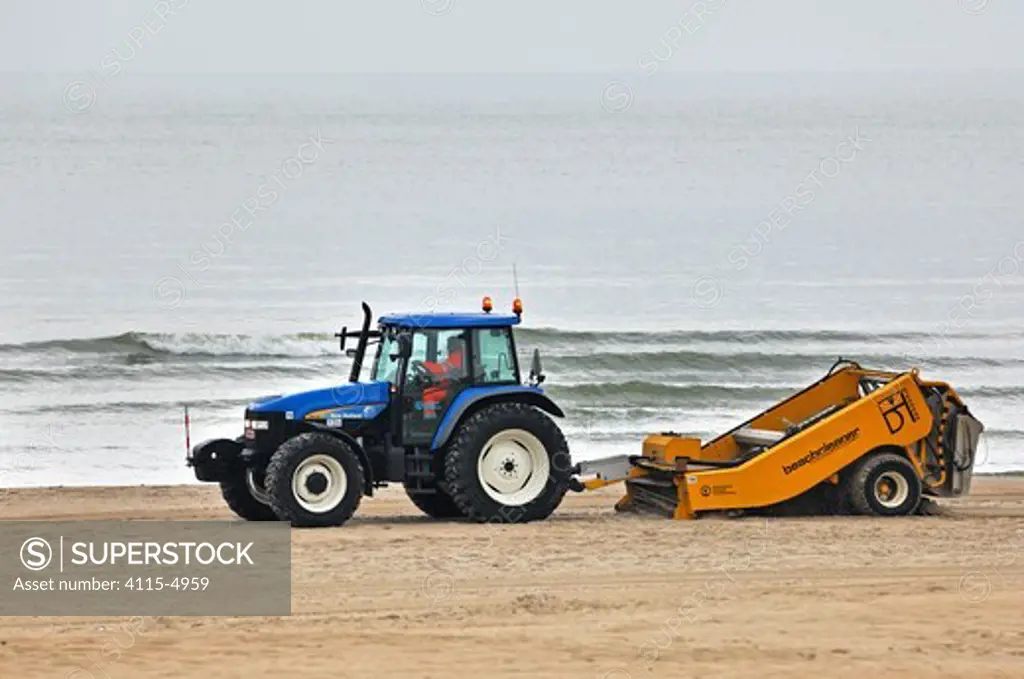 Tractor cleaning beach sand, Belgium