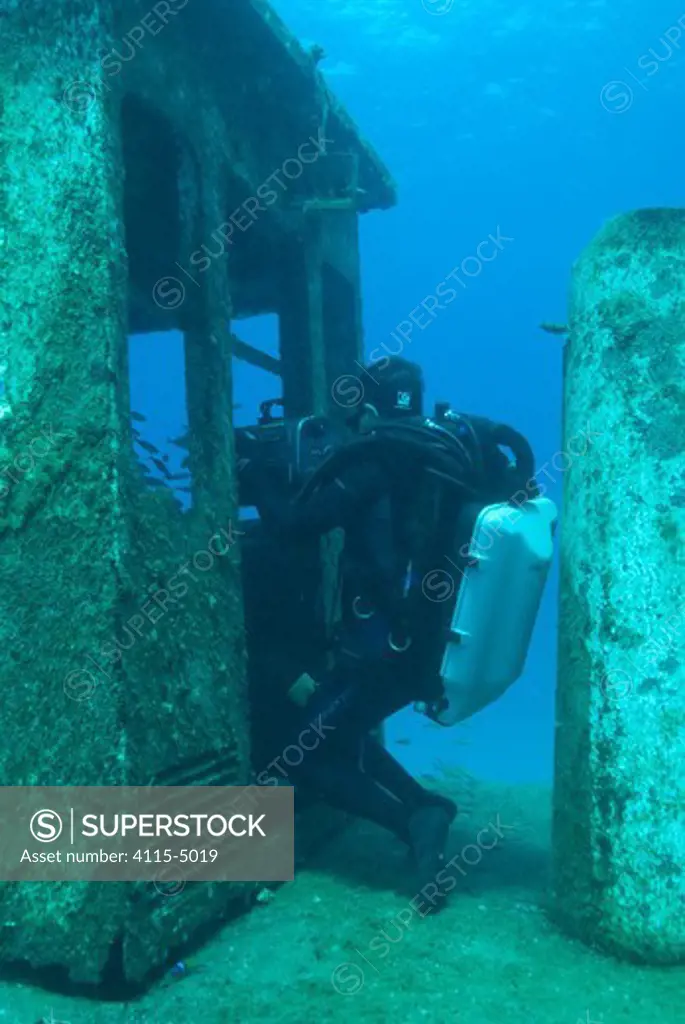Cameraman Mike Pitts filming underwater for the BBC series 'Life' in a sunken tug boat, off the coast of the Bahamas, Caribbean, February 2007