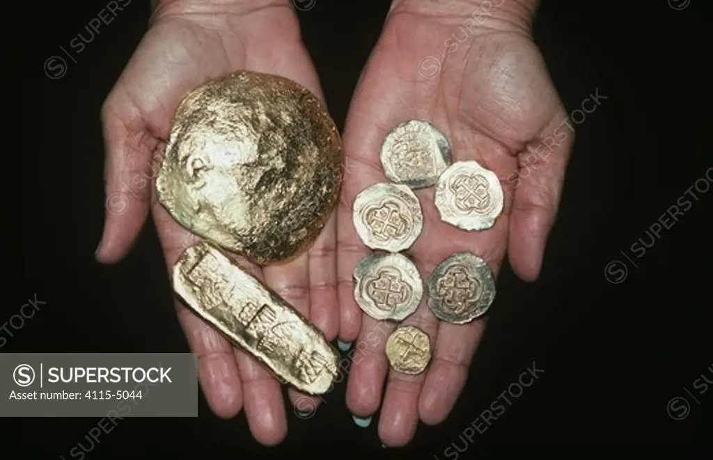 Gold Doubloons and gold bar recovered from the shipwreck ""Las Maravillas"", a Spanish galleon sunk in 1658, Bahamas. 1987. model released