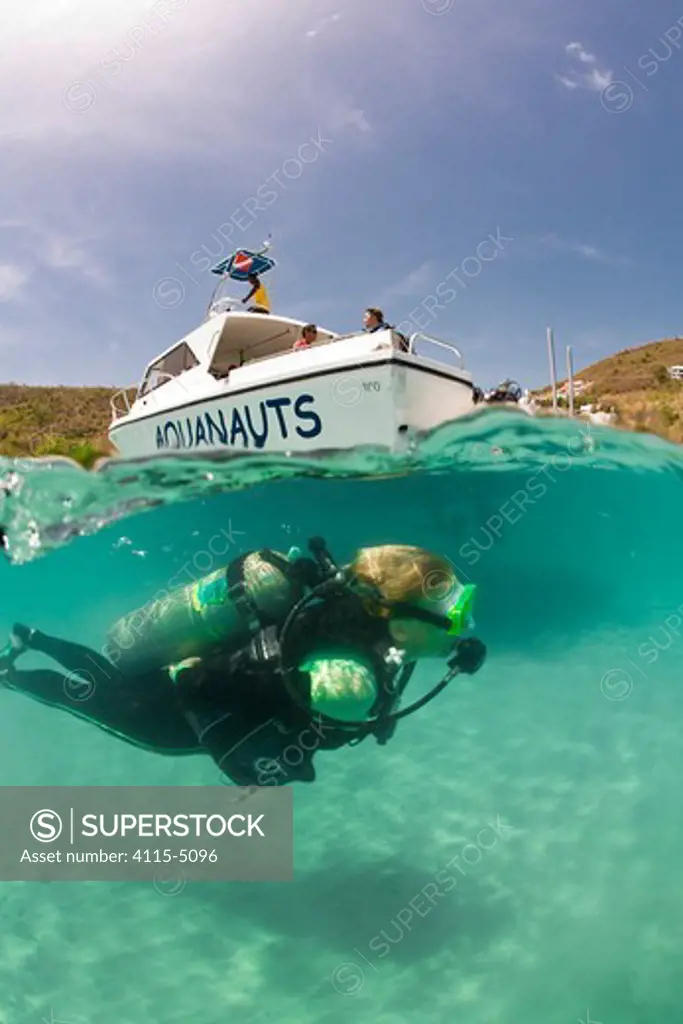 Split level view of scuba diver with PR Aquanauts boat in Grenada, Caribbean. May 2009. Property released and diver model released.