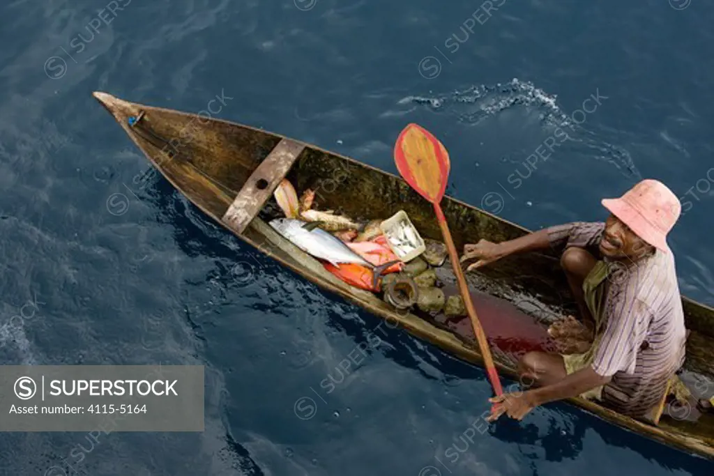 At sea off the Fak Fak Peninsula, a fisherman in a canoe caught a variety of fish including tuna, snappers, and groupers on a hand line. This is a good example of a healthy fishery. West Papua, Indonesia, April 2007