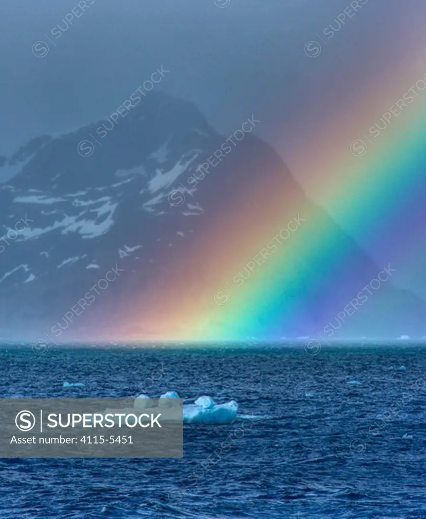 Rainbow over the sea with a small iceberg, South Georgia, December 2006