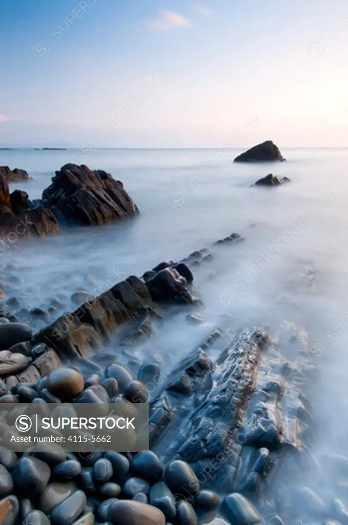 Sandymouth Bay, evening light and long exposure over rocks and pebbles, North Cornwall, England, UK. April 2010.