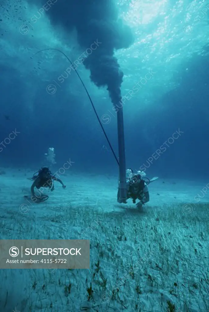 Sandblaster searching and blowing a magnetic hit during the recovery of the shipwreck ""Las Maravillas"", a Spanish galleon sunk in 1658, Bahamas. 1987. model released