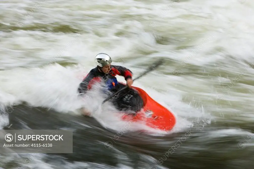 A kayaker plays in a hole in Tariffville Gorge on the Farmington River in Tariffville, Connecticut. Class III whitewater. May 2007. Model released.