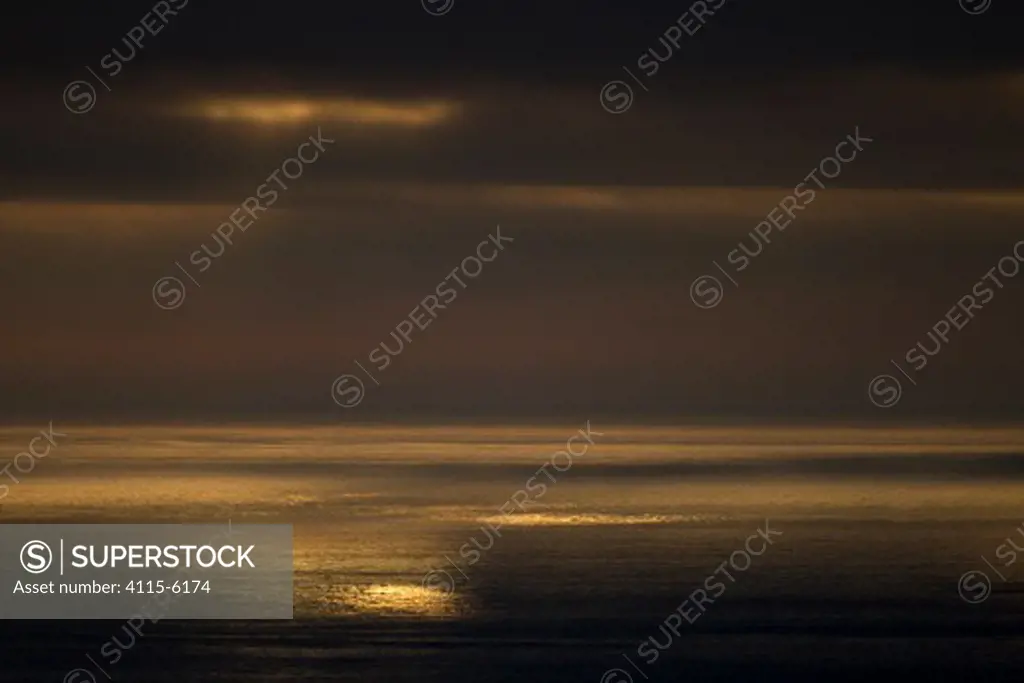 Dramatic light over sea at dusk. Hermaness NNR, Shetland, Scotland, June.