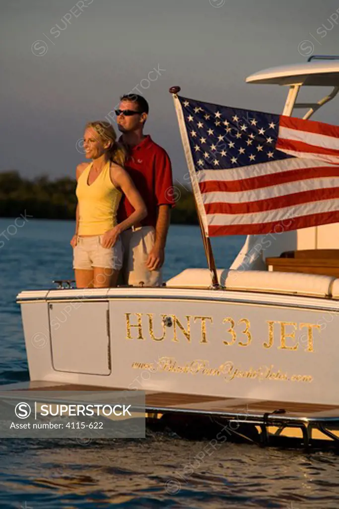 Couple aboard Surf Hunter 33 Jet boat off Marco Island, Florida.