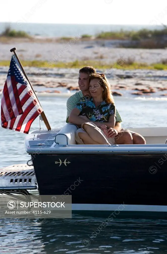Couple relaxing in the cockpit of Hunt Harrier 25 off Marco Island, Florida, USA