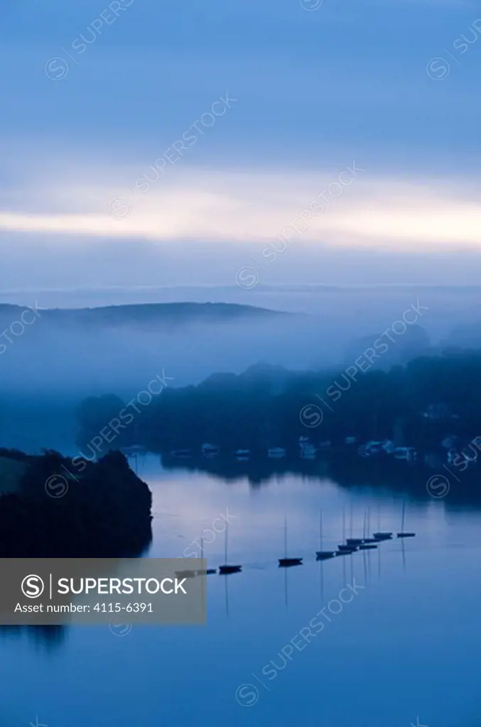 View of boats and estuary, looking toward Southpool Creek from Snapes Point in the early morning light and mist. Salcombe, South Devon, UK, September 2010