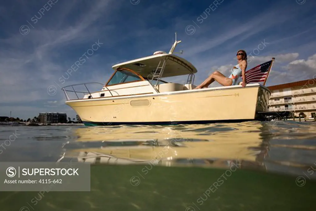Woman relaxing on the stern of a Surf Hunter 29 Inboard off Marco Island, Florida, USA