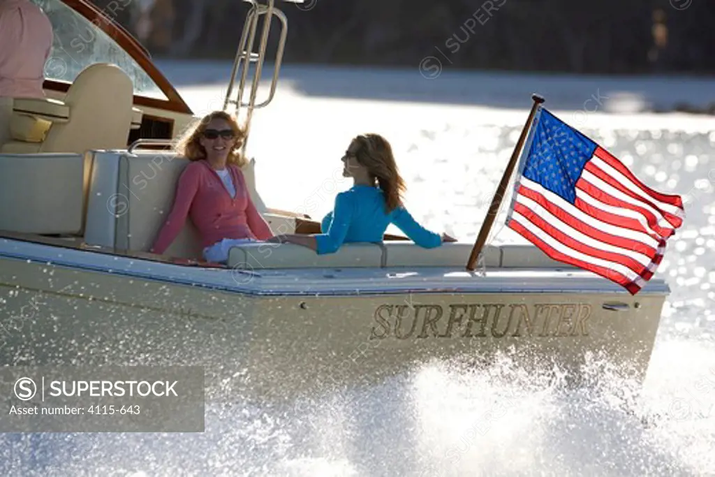 Women relaxing in the cockpit of a Surf Hunter 29 Inboard off Marco Island, Florida, USA