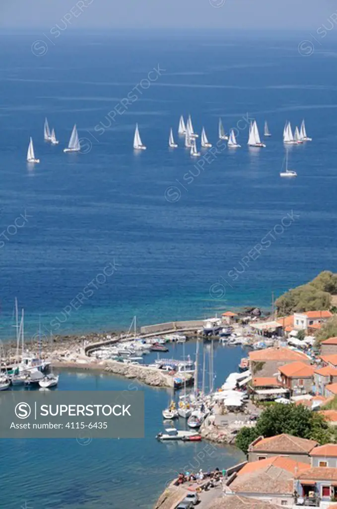 Overview of Molyvos / Mithymna harbour, and sailing yachts racing in the Aegean regatta. Lesbos / Lesvos, Greece, August 2010