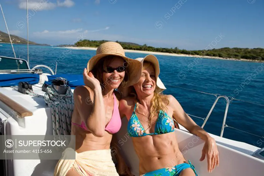 Two women relaxing on a yacht in the British Virgin Islands, Caribbean, March 2006.