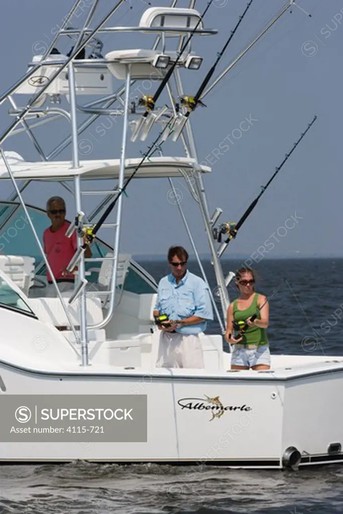 People fishing from the stern of a sportsfisher.