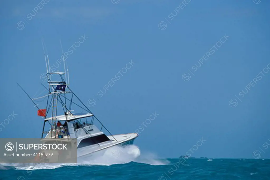 A large sport fishing boat heading out to sea from Key West, Florida Keys, Florida, USA.