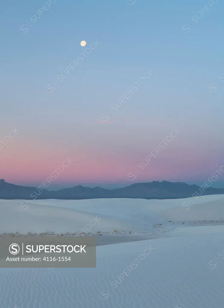 Near full moon in the pre-dawn, with the San Andreas Mtns and anti-twilight color, White Sands NM