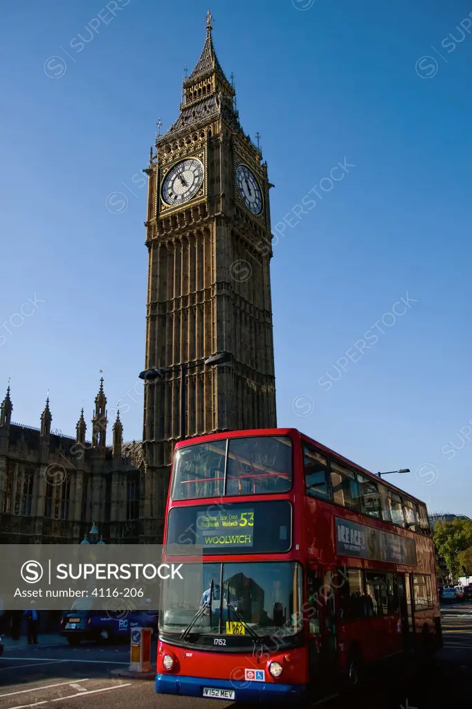 Double-decker bus passing by a monument, Big Ben, Houses Of Parliament, City Of Westminster, London, England