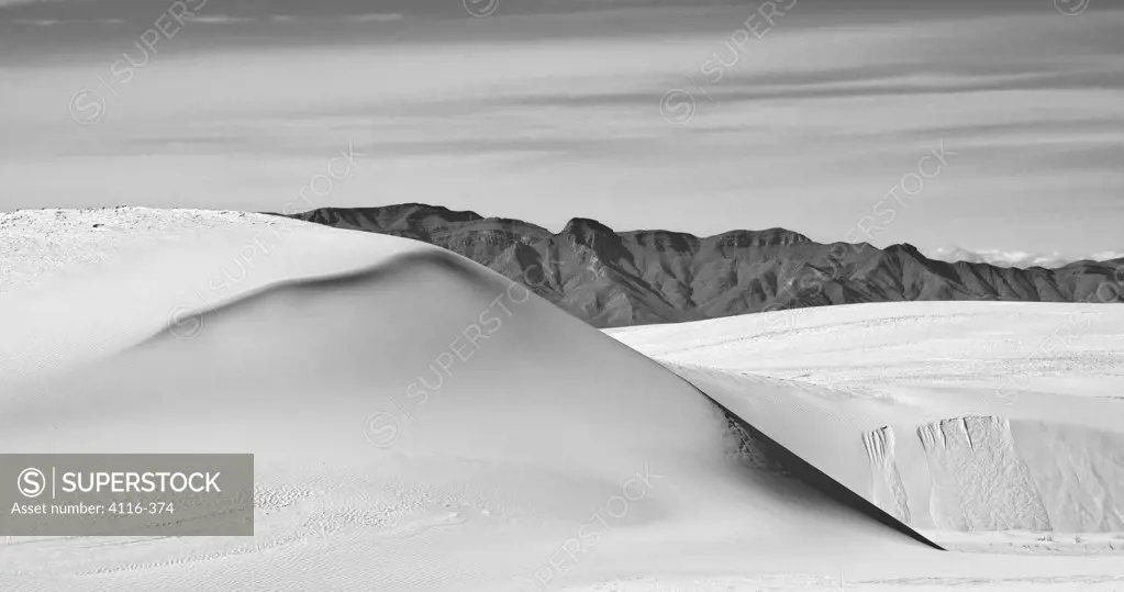 Gypsum sand dunes in a desert with mountains, White Sands National Monument, New Mexico, USA