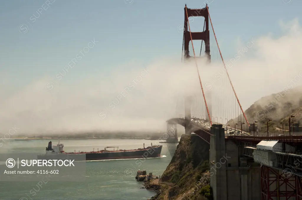 Container ship passing under the Golden Gate Bridge, San Francisco Bay, San Francisco, California, USA