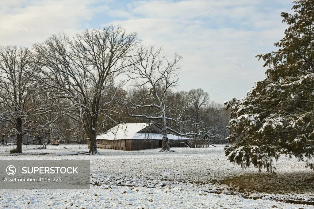 USA, Arkansas, Barns in field with snow
