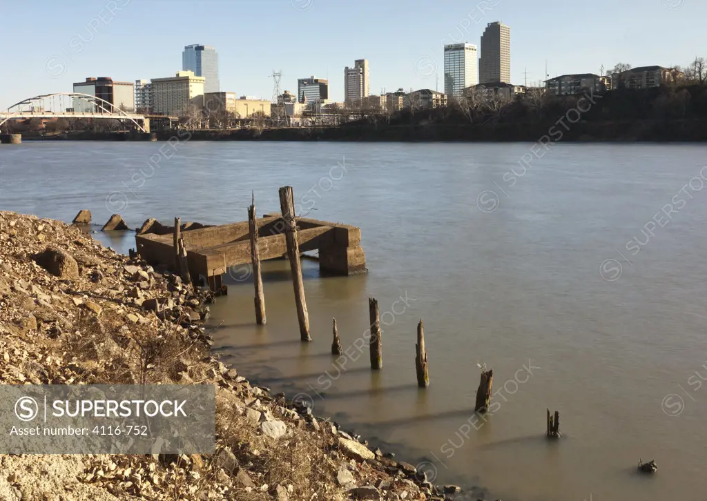 Dock ruins with skyscrapers in the background, Arkansas River, Little Rock, Arkansas, USA