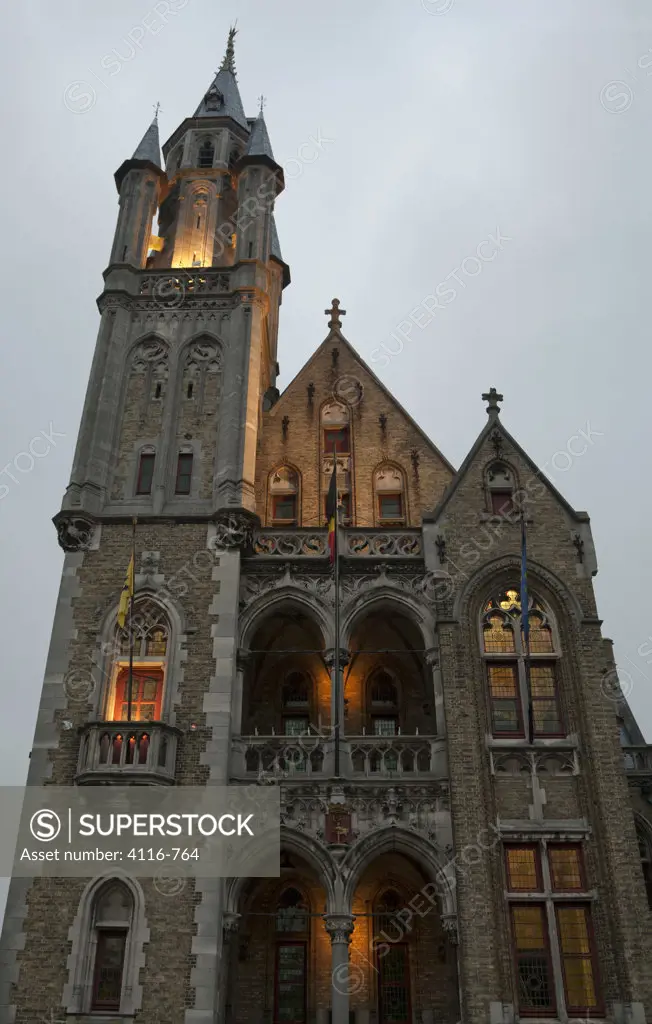 Low angle view of a church lit up at evening, Poperinge, West Flanders, Flemish Region, Belgium