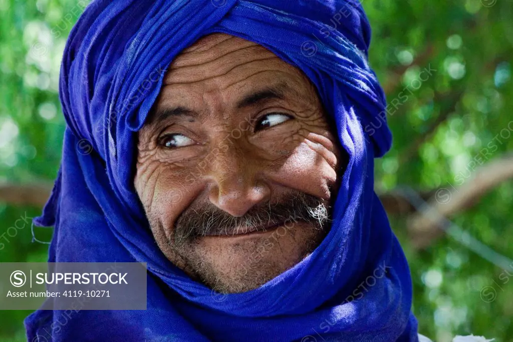 Closeup of a Moroccan man wearing a blue turbanin the Moroccan village of Setti Fatma, Ourika valley