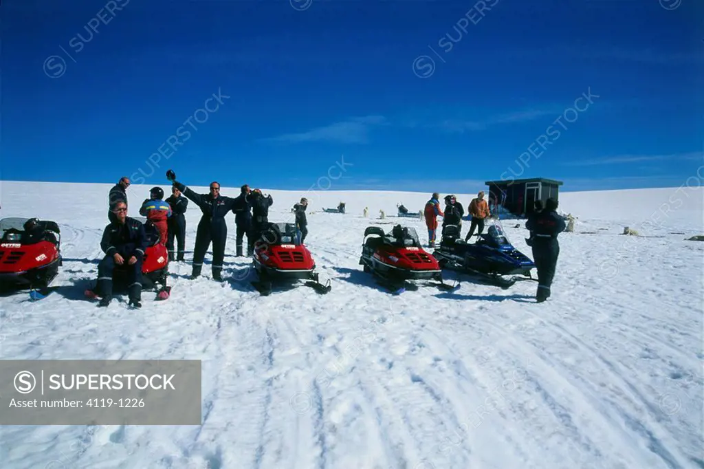 Photograph of a group of people preparing to ride their snowbikes in Iceland