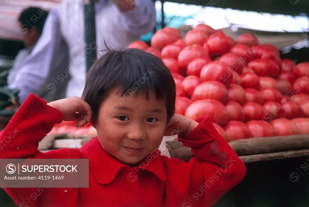 Photograph of a young Chinese boy in the local market