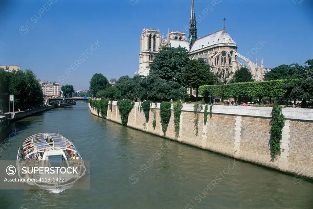 Photograph of a tour boat on the Seine river near the Notre_Dame Cathedral in Paris