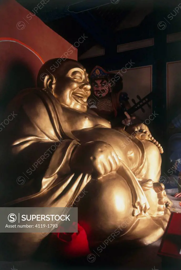 Photograph of a golden laughing Budha in a shrine in China
