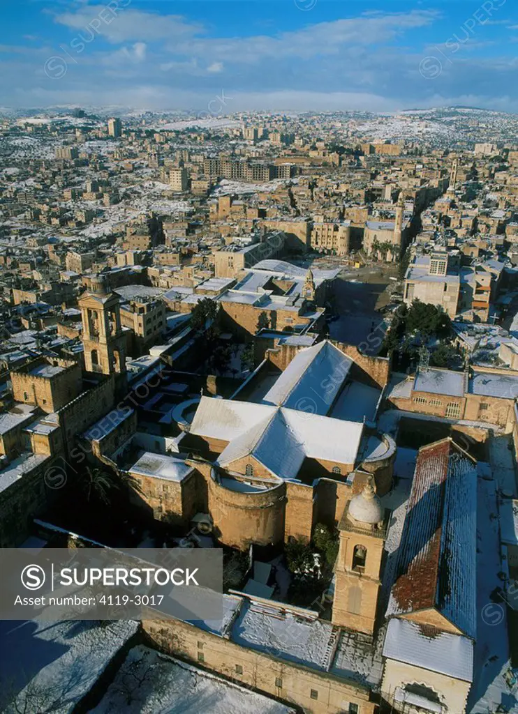 Aerial photograph of the church of nativity in the modern town of Bethlehem after snow fall