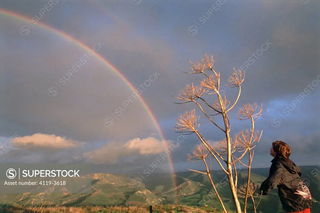 Photograph of a child watching a rainbow over the Golan Heights