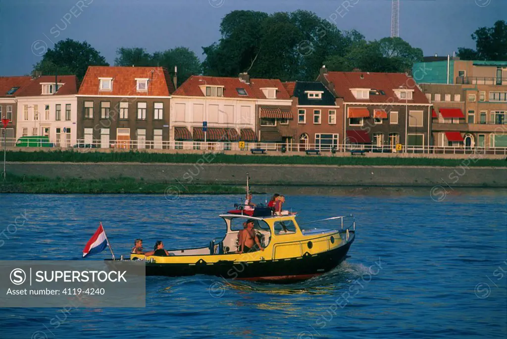 Photograph of a yello motor boat in a canal in Holland
