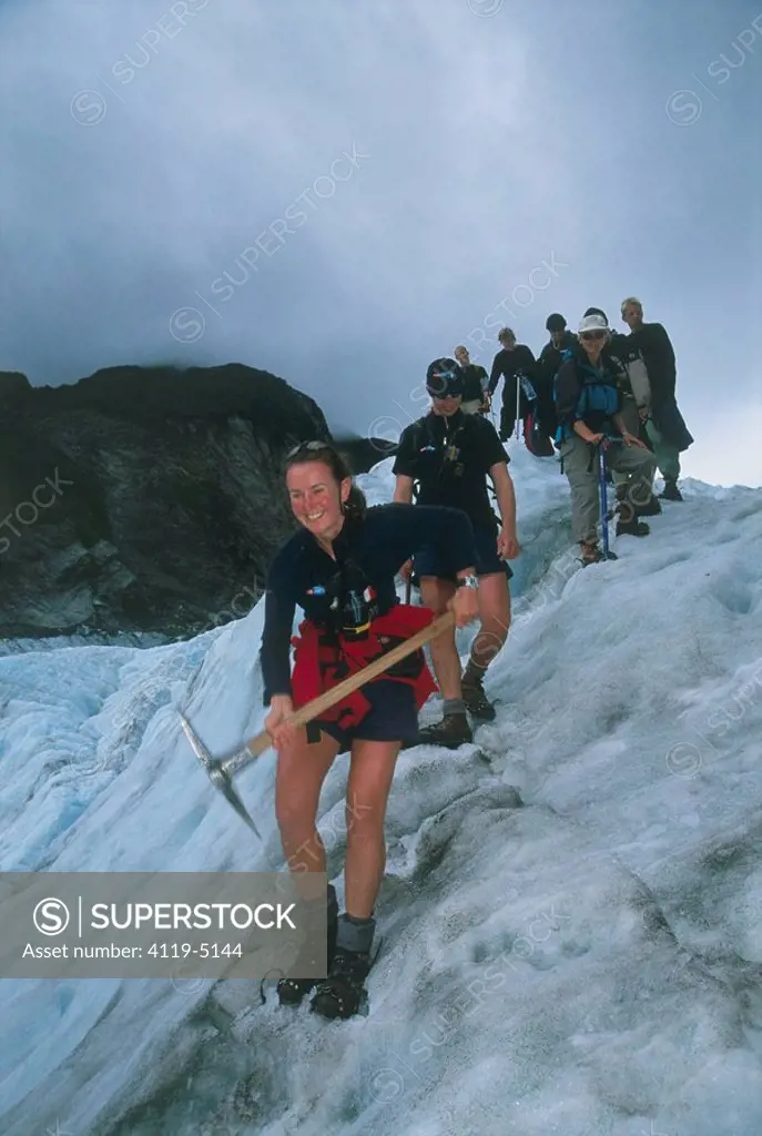 Photograph of a group of hikers on a glacier in New Zealand