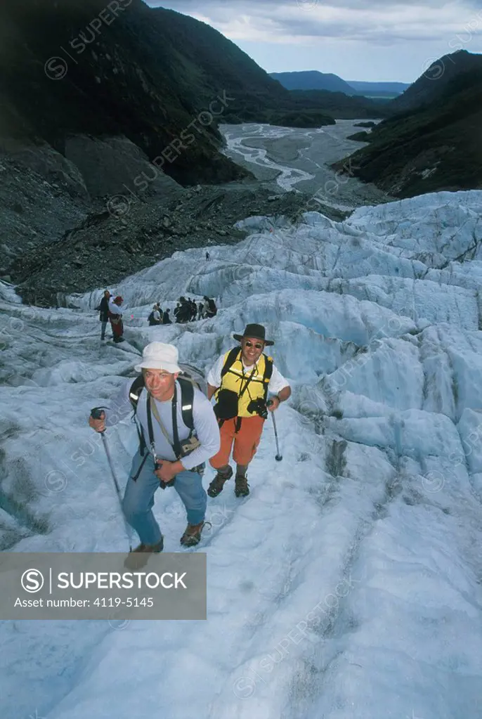 Photograph of a group of hikers on a glacier in New Zealand