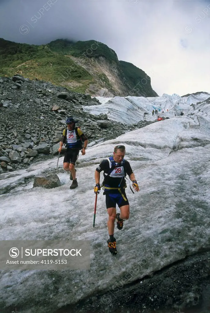 Photograph of two man running across a glacier in New Zealand