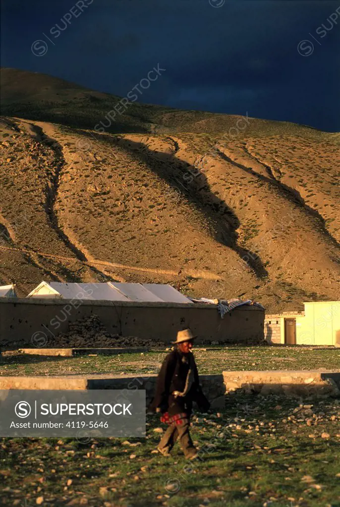 Tibatian man walking in a camp