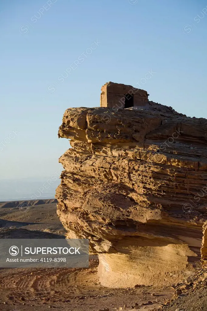 Abstract view of a stone house on a rock shaped as a giant mushroom in the Jordanian desert