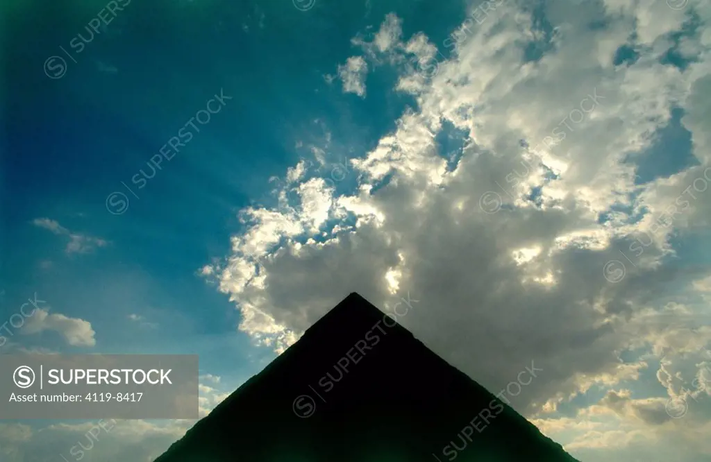 Photograph of the sun light emerging behind the pyramid´s silhouette in Egypt
