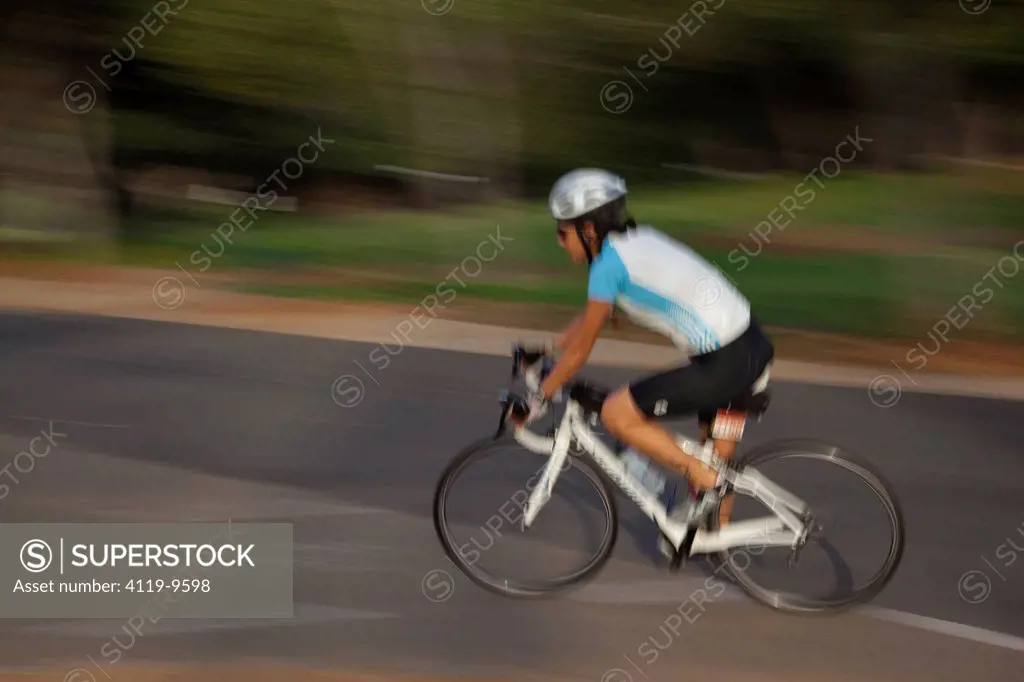 Photograph of a bicycle rider in the Yarkon Park _ the green lungs of the city of Tel Aviv