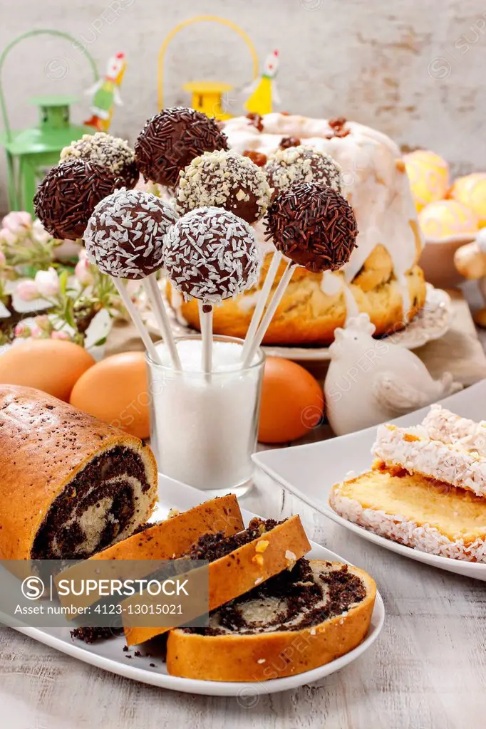 Chocolate cake pops and poppy seed cake on easter table. Festive dessert