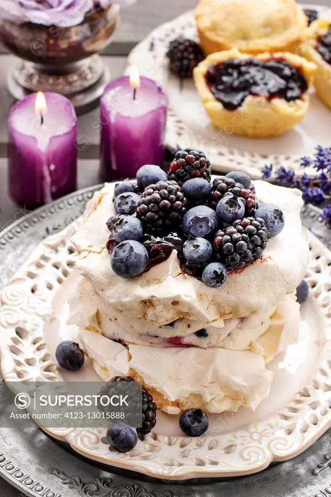 Pavlova cake with blueberries and blackberries. Party dessert